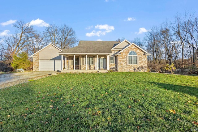 view of front of property with a front lawn, covered porch, and a garage