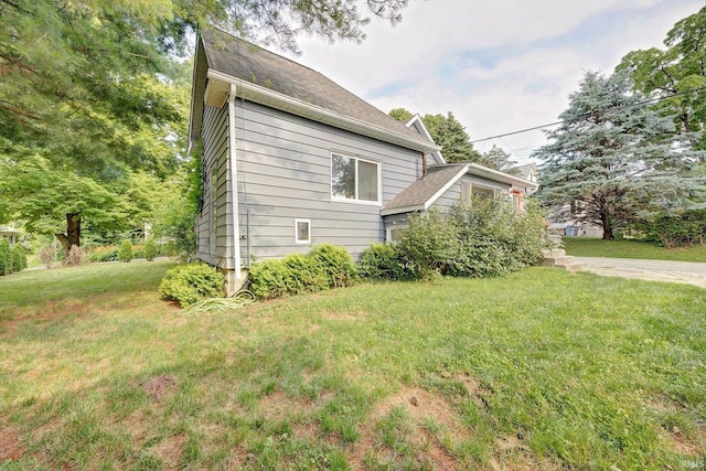 view of side of home featuring a yard