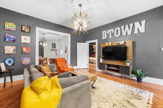 living room with hardwood / wood-style flooring and an inviting chandelier