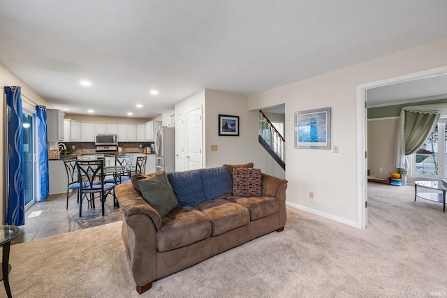 carpeted living room with sink