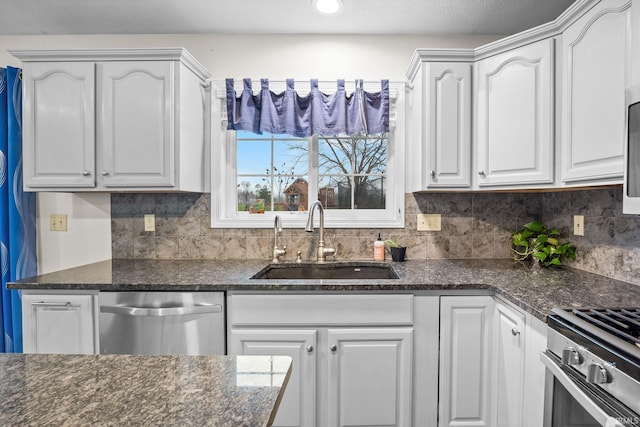 kitchen with white cabinets, stainless steel appliances, tasteful backsplash, and sink