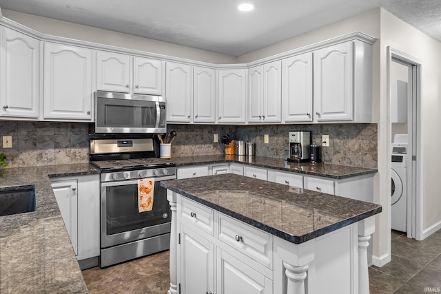 kitchen featuring tasteful backsplash, white cabinets, and appliances with stainless steel finishes