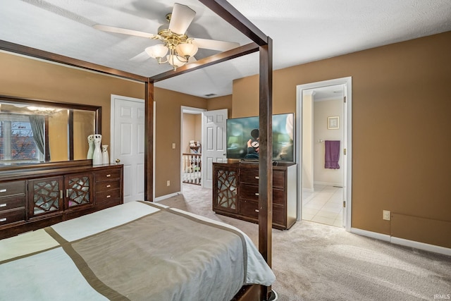 carpeted bedroom with a textured ceiling, ceiling fan, and ensuite bathroom