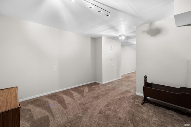 interior space featuring carpet and rail lighting