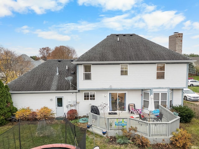 4819 Osprey Dr E, Lafayette, IN 47909 - rear view of house featuring a chimney, roof with shingles, a yard, and a deck
