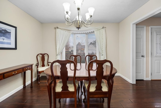 dining area featuring dark hardwood / wood-style flooring and a notable chandelier