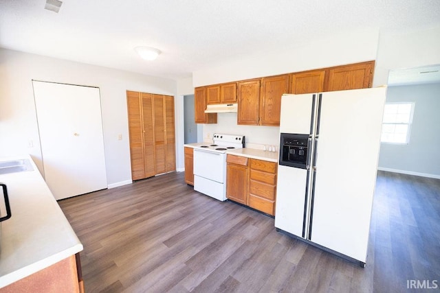 kitchen featuring dark hardwood / wood-style flooring and white appliances