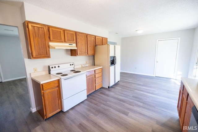 kitchen featuring wood-type flooring, white appliances, and a textured ceiling