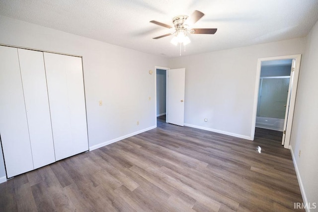 unfurnished bedroom with ceiling fan, a closet, a textured ceiling, and hardwood / wood-style flooring