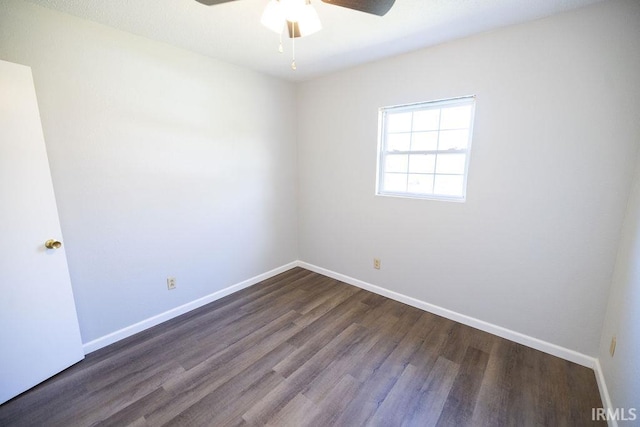 unfurnished room with ceiling fan and dark wood-type flooring