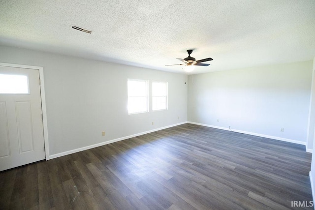 foyer entrance featuring a textured ceiling, dark hardwood / wood-style flooring, and ceiling fan