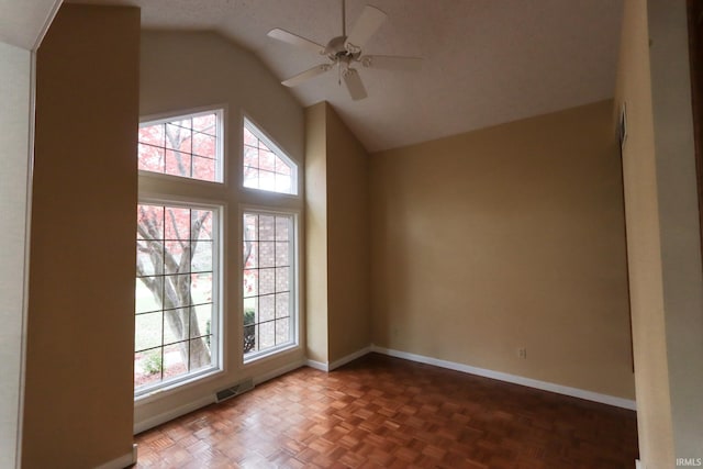 additional living space with plenty of natural light, ceiling fan, dark parquet flooring, and lofted ceiling