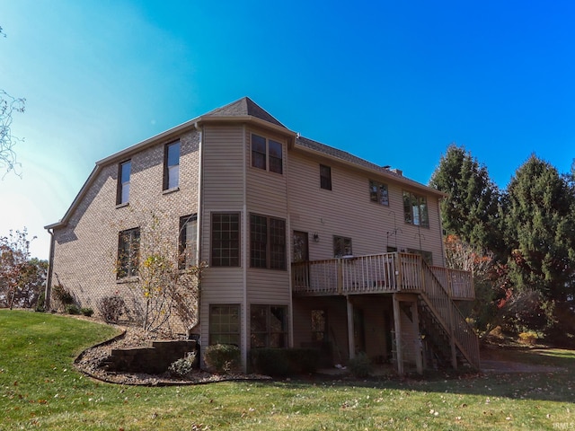 rear view of house with a yard and a wooden deck