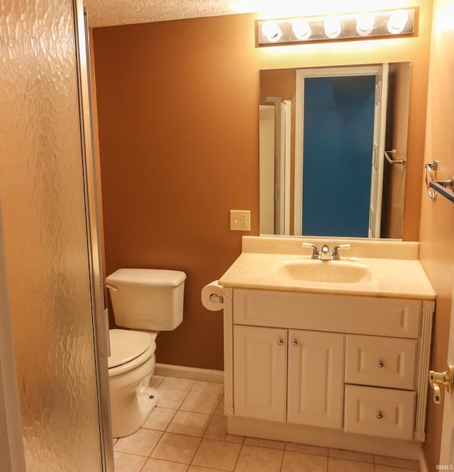 bathroom featuring tile patterned floors, an enclosed shower, vanity, a textured ceiling, and toilet