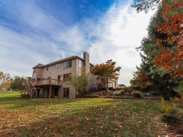 rear view of house with a yard and a deck