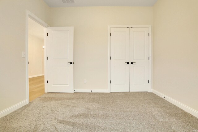 unfurnished bedroom with carpet floors and a closet