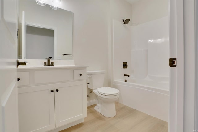 full bathroom featuring wood-type flooring, tub / shower combination, vanity, and toilet