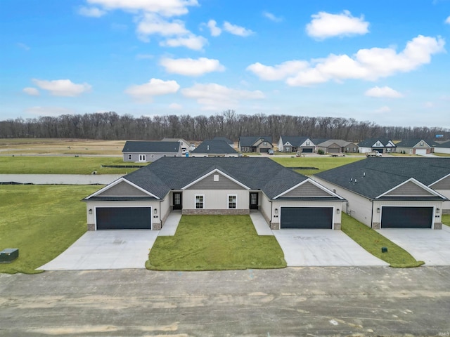 view of front of property featuring a garage and a front lawn