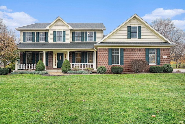 view of front facade with covered porch and a front yard