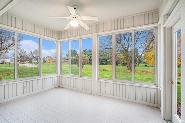 unfurnished sunroom with ceiling fan