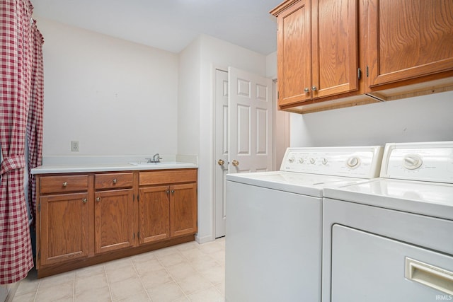 laundry room featuring cabinets, separate washer and dryer, and sink