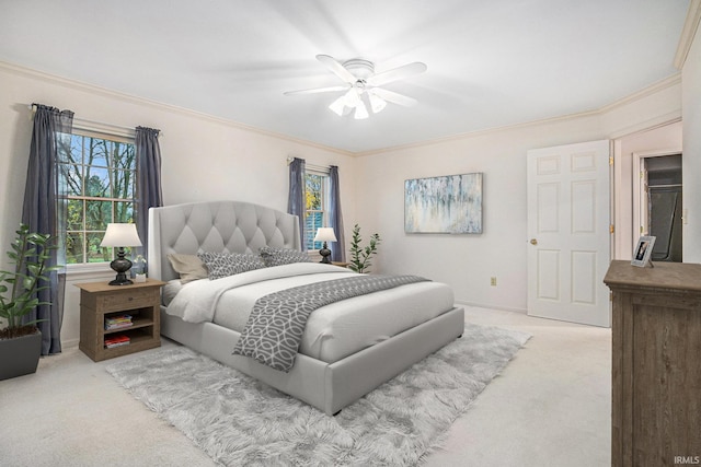 carpeted bedroom featuring ceiling fan and ornamental molding