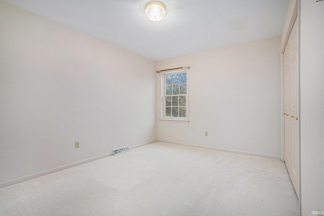 unfurnished bedroom featuring light carpet