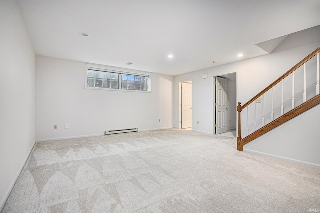 carpeted spare room featuring a baseboard heating unit