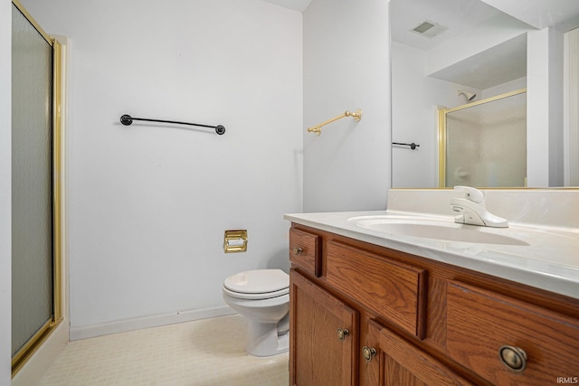 bathroom featuring vanity, toilet, and walk in shower