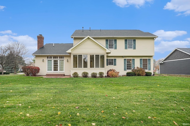 back of house with a yard