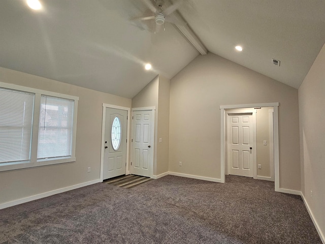 foyer entrance with ceiling fan, lofted ceiling with beams, and dark colored carpet