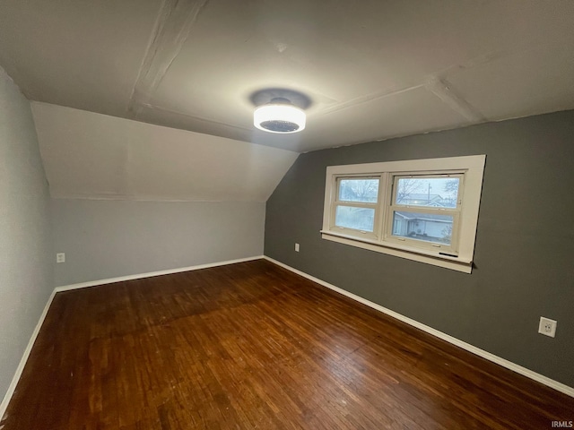 bonus room featuring dark hardwood / wood-style flooring and lofted ceiling