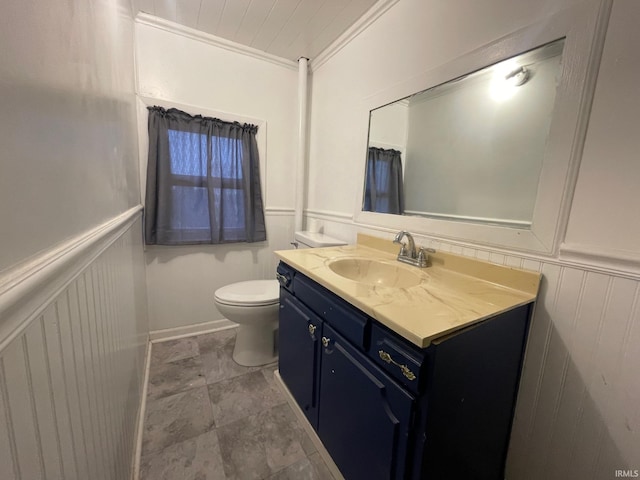 bathroom with vanity, toilet, and crown molding