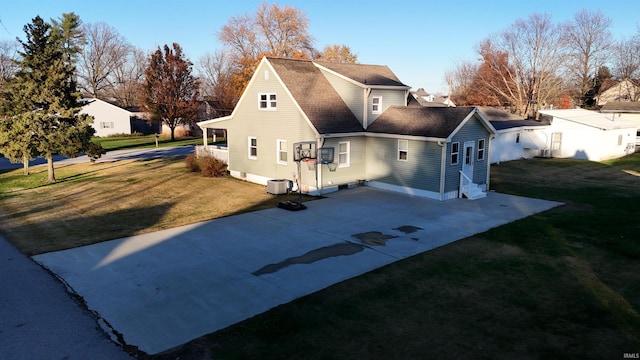 exterior space featuring a front yard and central AC unit