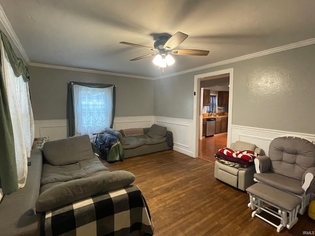 living room featuring ceiling fan, dark hardwood / wood-style flooring, and ornamental molding