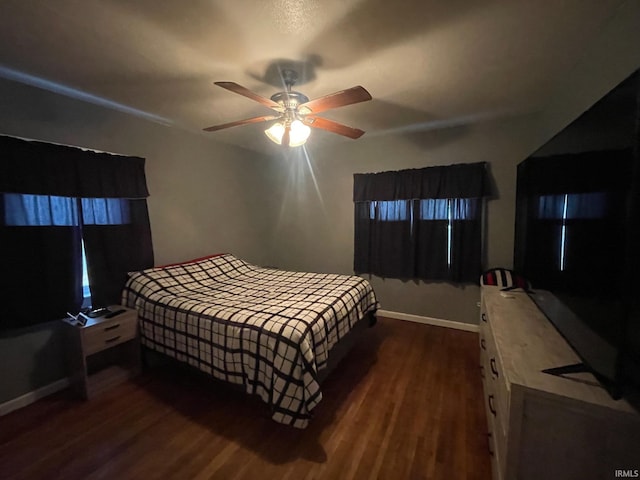 bedroom with ceiling fan and dark hardwood / wood-style flooring