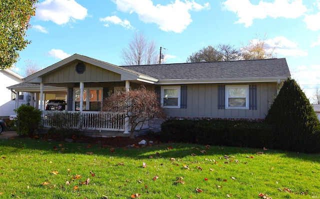 ranch-style home featuring a porch, a carport, and a front lawn