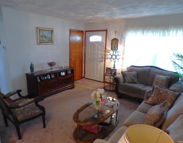 living room featuring a textured ceiling and light carpet