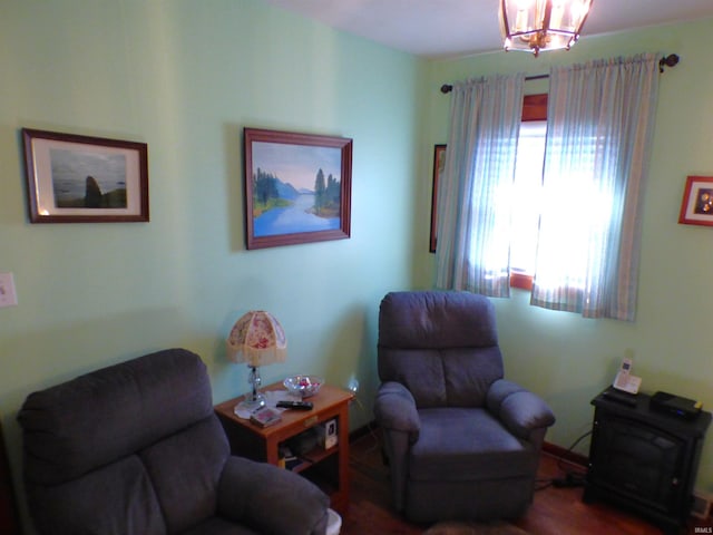 living area with wood-type flooring and a notable chandelier