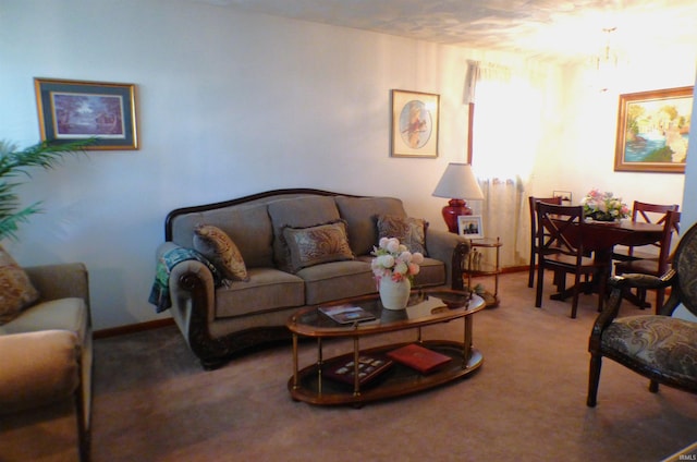 carpeted living room with an inviting chandelier