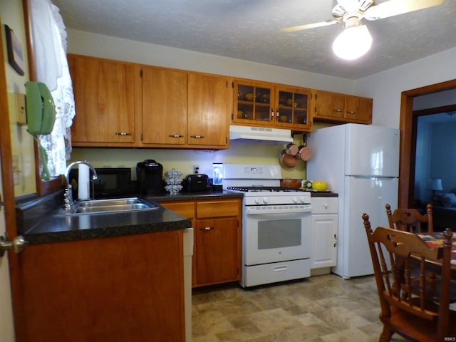 kitchen with a textured ceiling, ceiling fan, sink, and white appliances