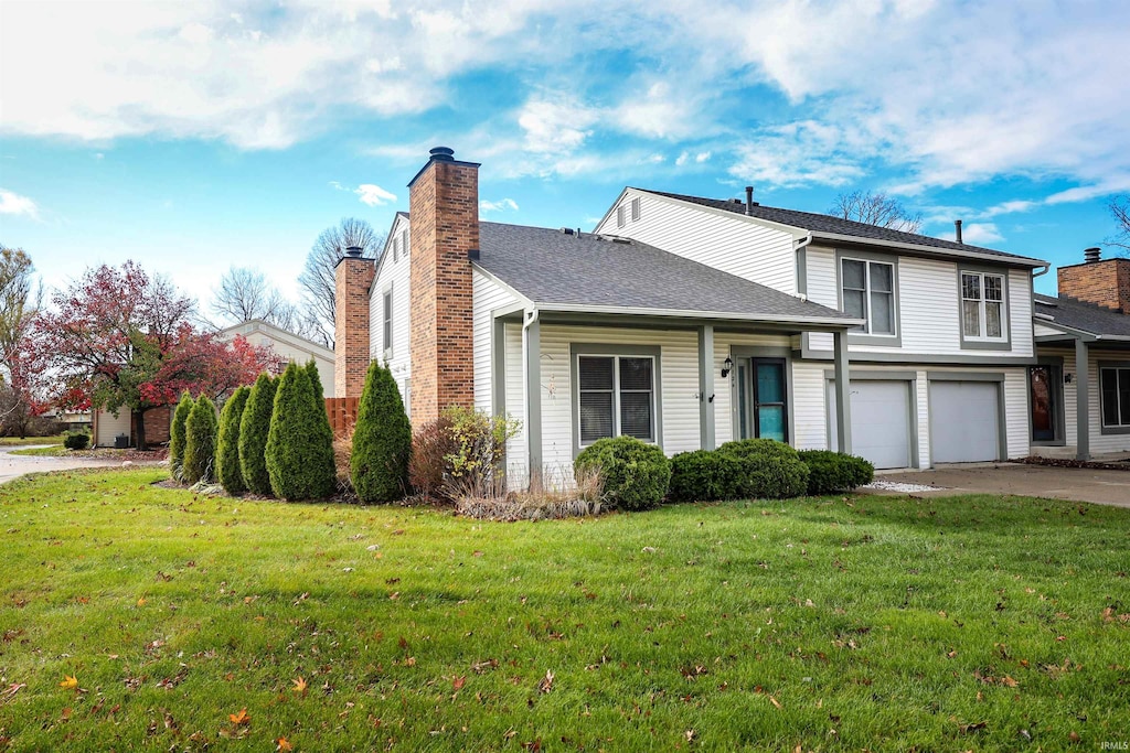 view of front facade featuring a front yard and a garage