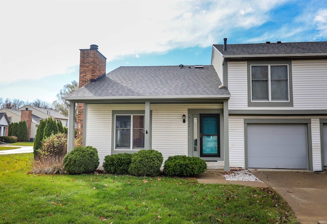 view of front of home with a garage and a front lawn