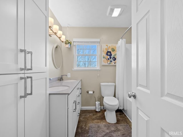 bathroom featuring walk in shower, vanity, and toilet