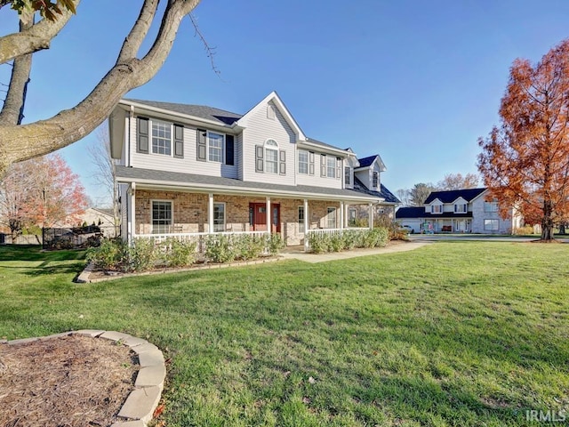 view of front of home with a porch and a front lawn