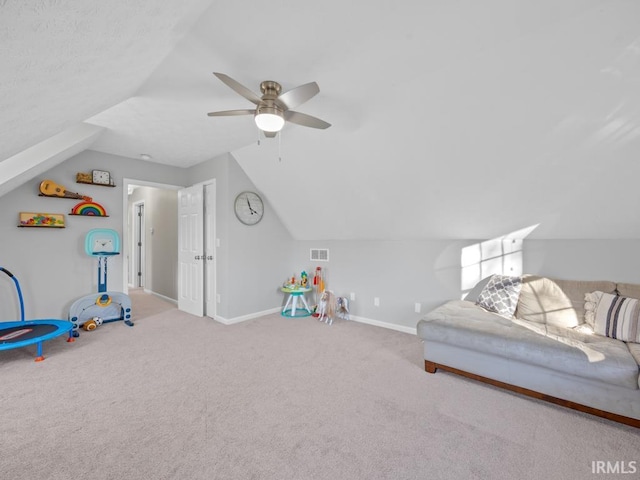 playroom with carpet, ceiling fan, and vaulted ceiling