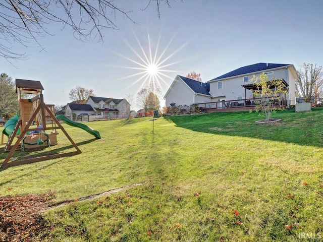 view of yard featuring a playground and a wooden deck