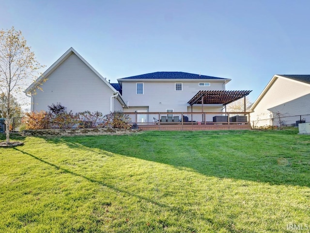 rear view of property with a deck, a pergola, and a yard