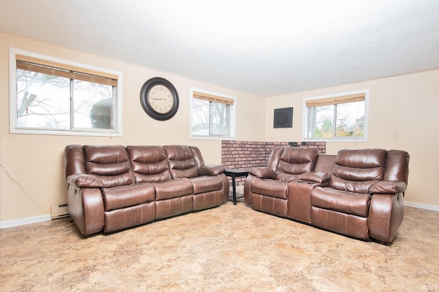 carpeted living room featuring a healthy amount of sunlight and a baseboard heating unit