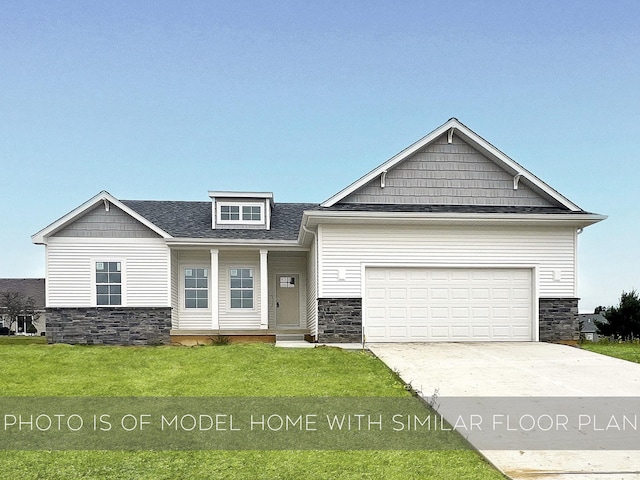 craftsman inspired home with a garage and a front lawn